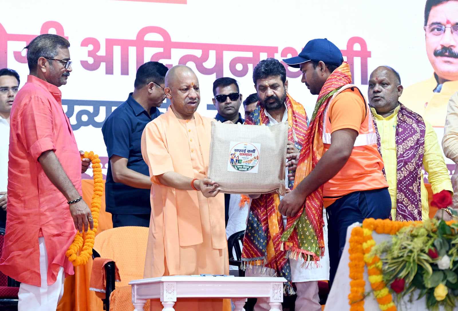 Hon'ble Chief Minister Yogi Adityanath ji felicitating sanitation workers at the Sanitation Workers' Felicitation Ceremony held at Saroja Palace, Kabirchaura, Varanasi on October 15, 2026.