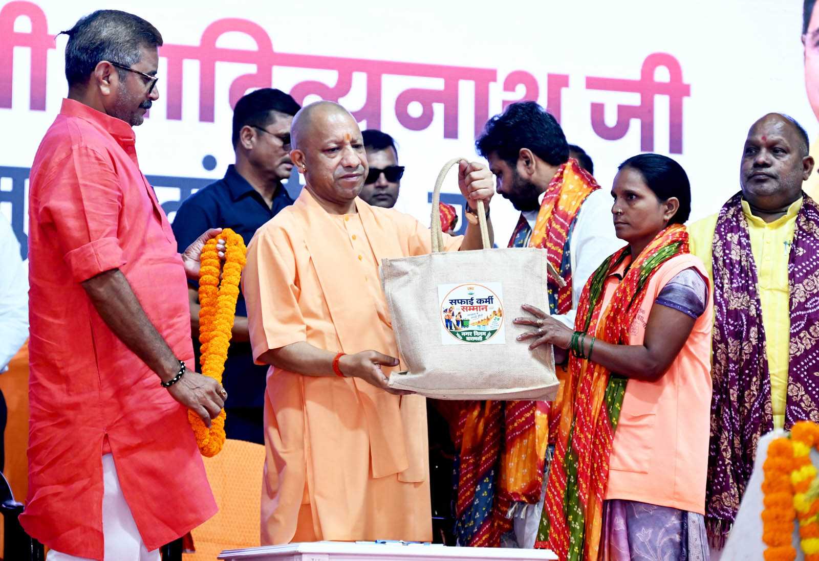 Hon'ble Chief Minister Yogi Adityanath ji felicitating sanitation workers at the Sanitation Workers' Felicitation Ceremony held at Saroja Palace, Kabirchaura, Varanasi on October 15, 2026.