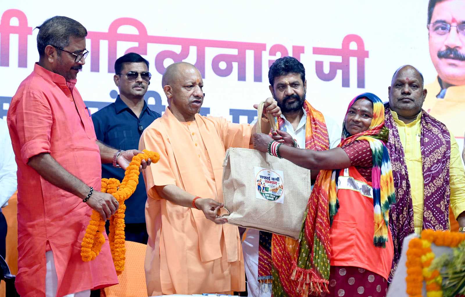 Hon'ble Chief Minister Yogi Adityanath ji felicitating sanitation workers at the Sanitation Workers' Felicitation Ceremony held at Saroja Palace, Kabirchaura, Varanasi on October 15, 2026.