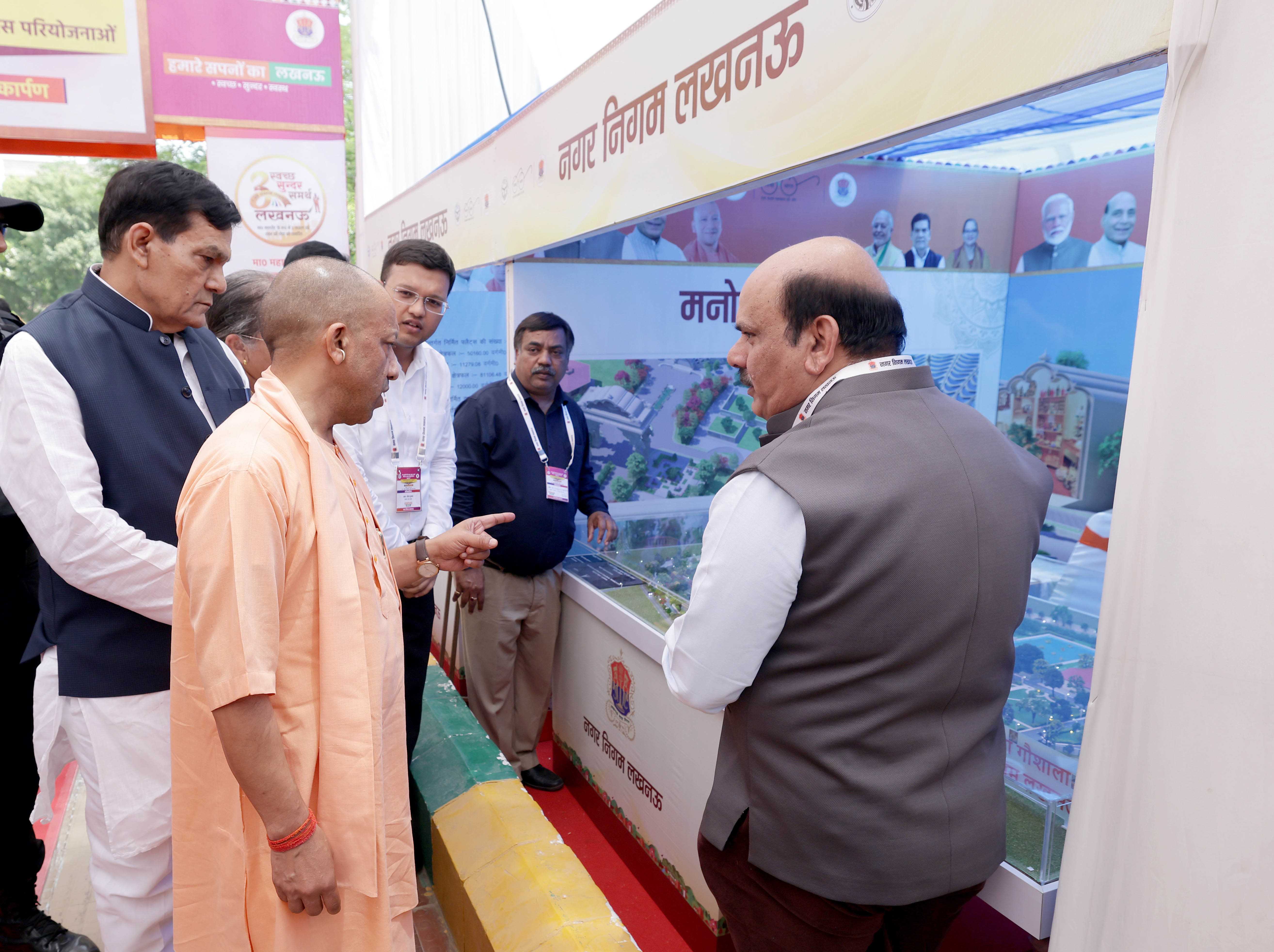 Honorable Chief Minister Yogi Adityanath observing an exhibition organized in Lucknow on May 26, 2026, on the occasion of the inauguration and laying of foundation stones for various development projects of the Lucknow Municipal Corporation.