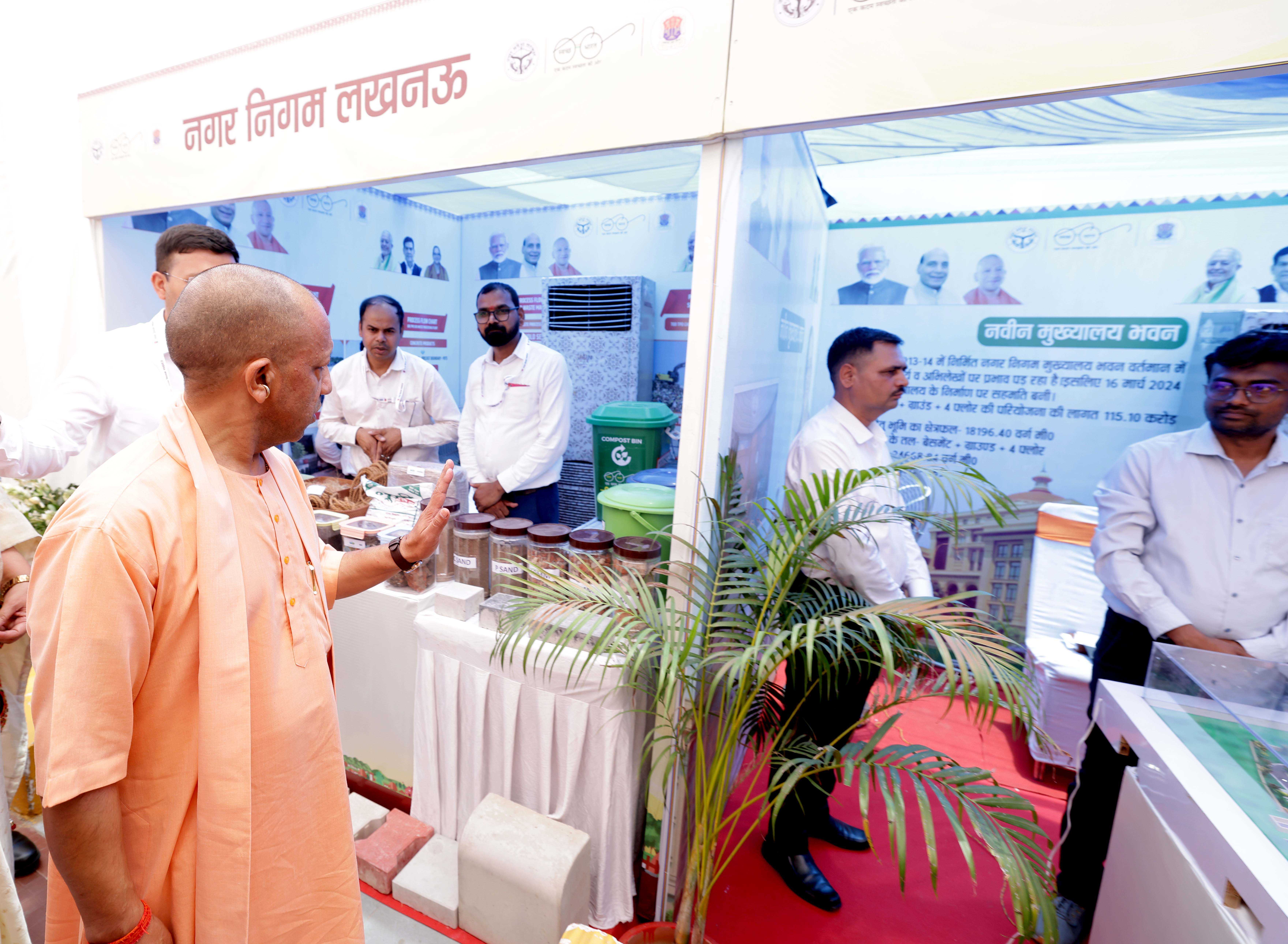 Honorable Chief Minister Yogi Adityanath observing an exhibition organized in Lucknow on May 26, 2026, on the occasion of the inauguration and laying of foundation stones for various development projects of the Lucknow Municipal Corporation.