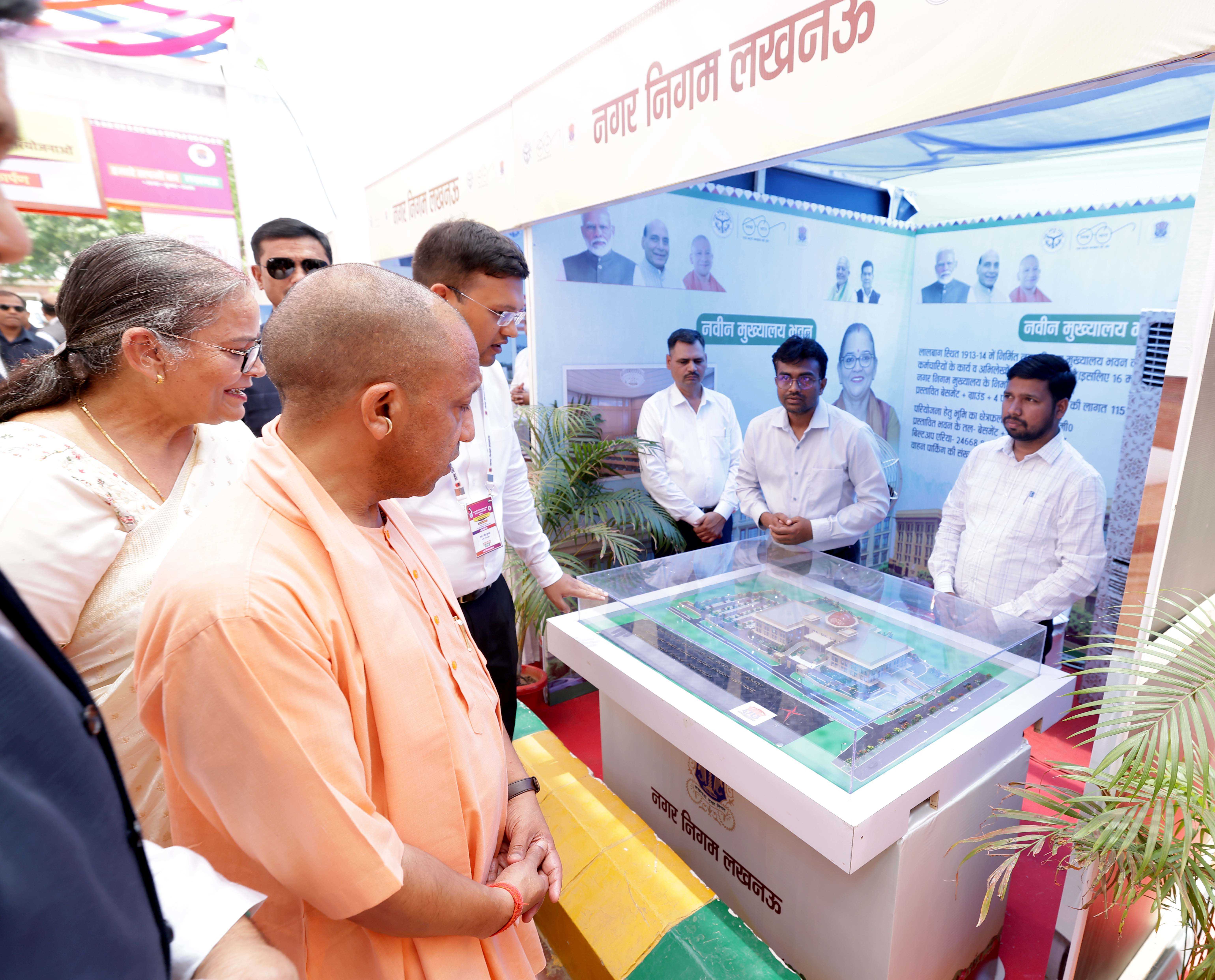 Honorable Chief Minister Yogi Adityanath observing an exhibition organized in Lucknow on May 26, 2026, on the occasion of the inauguration and laying of foundation stones for various development projects of the Lucknow Municipal Corporation.